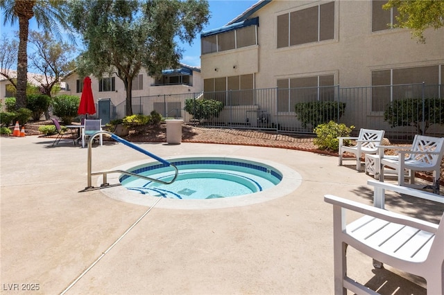 view of swimming pool with a community hot tub and a patio area