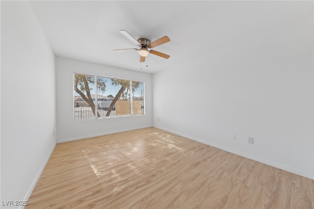 empty room with ceiling fan and light hardwood / wood-style floors