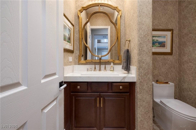 bathroom featuring vanity and toilet