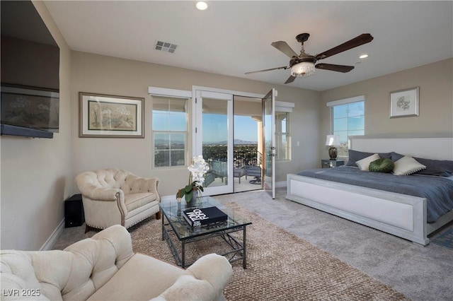 bedroom featuring multiple windows, access to outside, light colored carpet, and ceiling fan