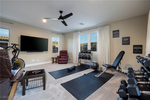 workout room featuring ceiling fan and carpet flooring