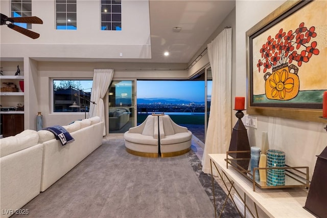 living room featuring ceiling fan and built in features