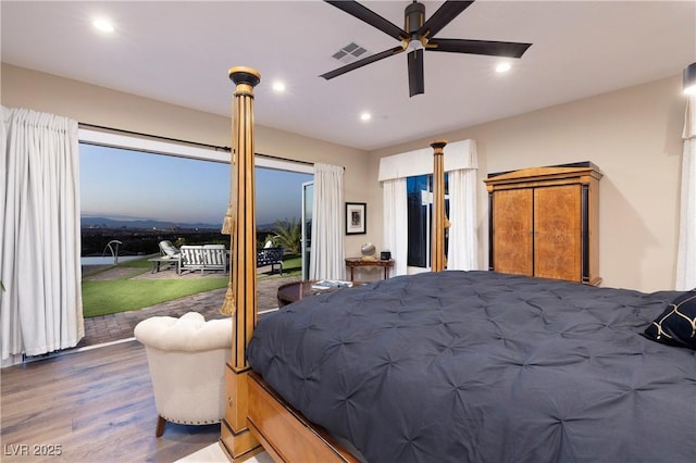 bedroom featuring access to outside, hardwood / wood-style floors, and ceiling fan