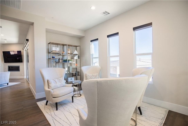 sitting room with dark wood-type flooring