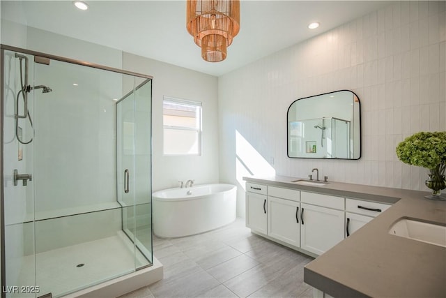 bathroom featuring vanity, shower with separate bathtub, tile walls, and tile patterned floors