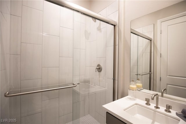 bathroom with vanity and a shower with shower door