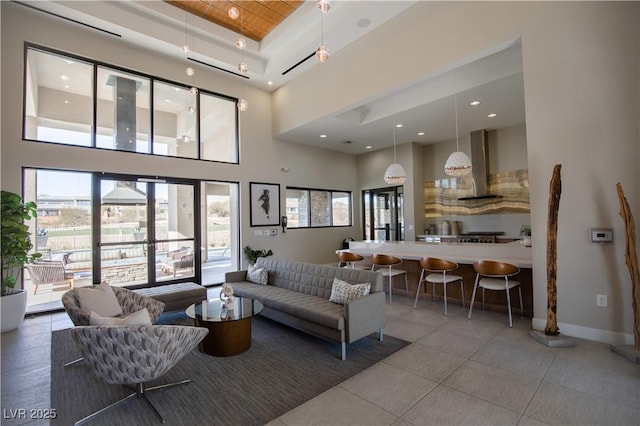 living room with tile patterned flooring and a towering ceiling