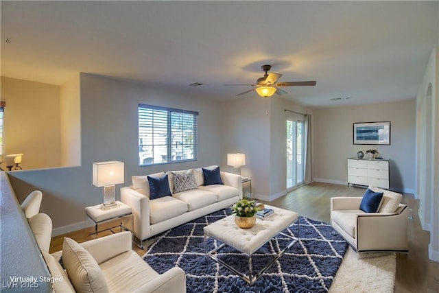 living room with ceiling fan, hardwood / wood-style floors, and a wealth of natural light