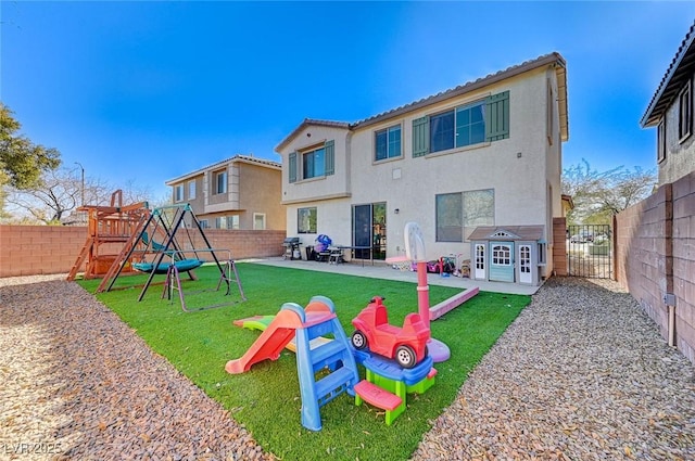 view of playground featuring a yard and a patio