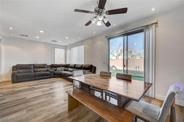 dining room featuring light hardwood / wood-style floors and ceiling fan