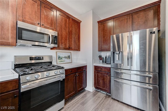 kitchen featuring appliances with stainless steel finishes and light wood-type flooring