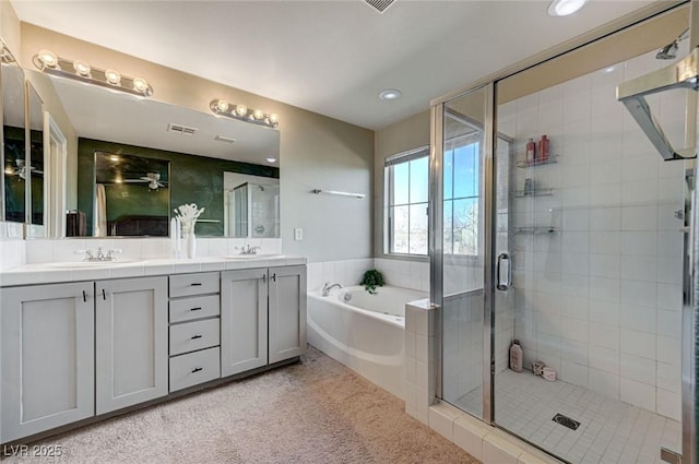 bathroom with vanity and separate shower and tub