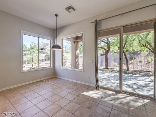 unfurnished dining area featuring light tile patterned flooring