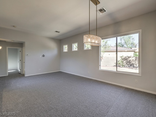 spare room featuring dark colored carpet