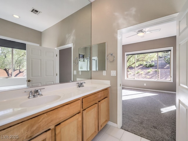 bathroom featuring ceiling fan, vanity, and tile patterned flooring