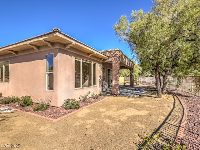 view of side of property featuring a patio