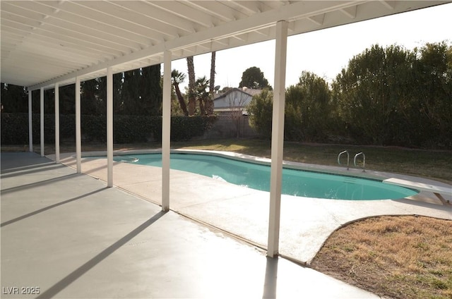 view of pool with a diving board and a patio