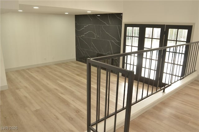 interior space featuring hardwood / wood-style flooring, plenty of natural light, and tile walls