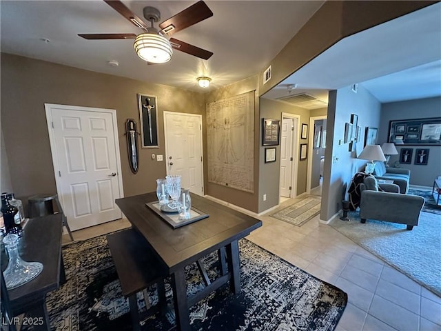 tiled dining space featuring ceiling fan