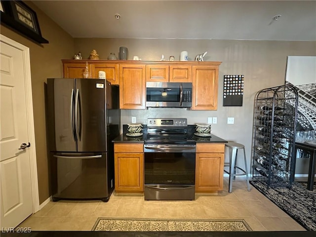 kitchen featuring stainless steel appliances and light tile patterned floors