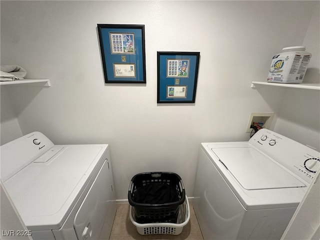 laundry room with washing machine and clothes dryer and tile patterned floors