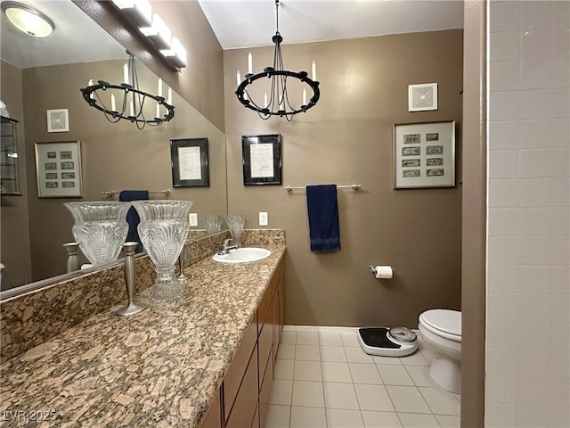 bathroom featuring vanity, tile patterned floors, toilet, and a chandelier