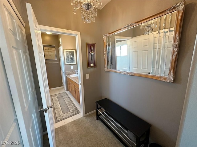 bathroom featuring vanity, a chandelier, and tile patterned flooring