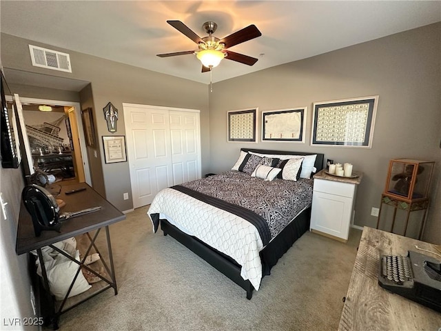 carpeted bedroom featuring a closet and ceiling fan