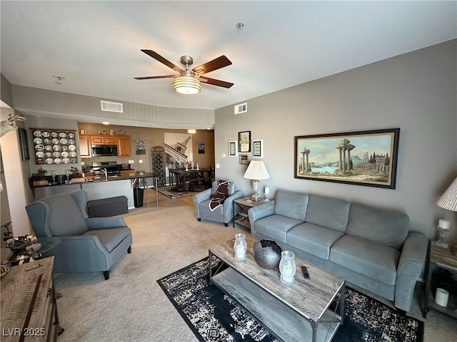 carpeted living room featuring ceiling fan