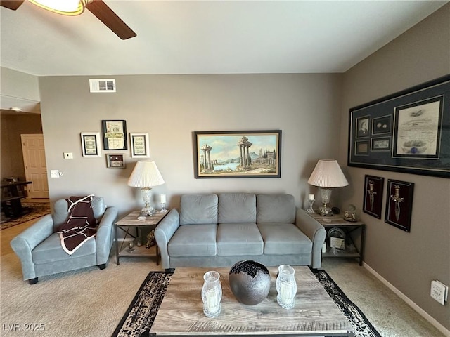 living room with ceiling fan and carpet