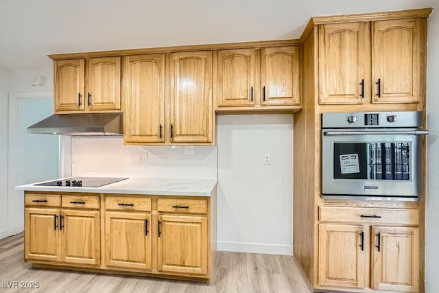 kitchen with tasteful backsplash, black electric stovetop, stainless steel oven, and light hardwood / wood-style floors