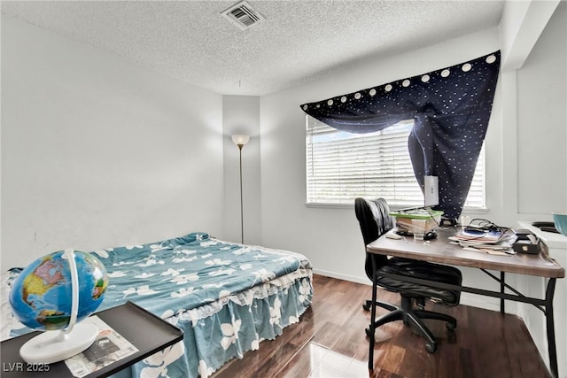 bedroom featuring hardwood / wood-style floors and a textured ceiling