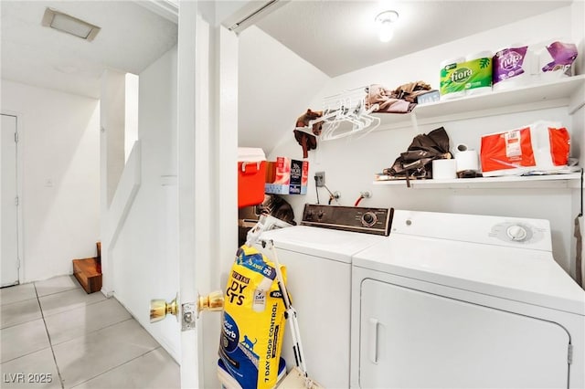 washroom featuring light tile patterned flooring and washing machine and clothes dryer