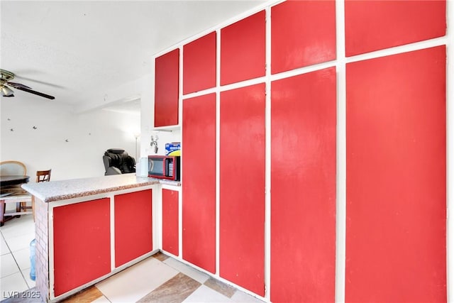 kitchen featuring a textured ceiling, ceiling fan, and light tile patterned flooring