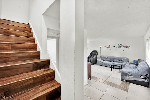 stairs featuring tile patterned flooring