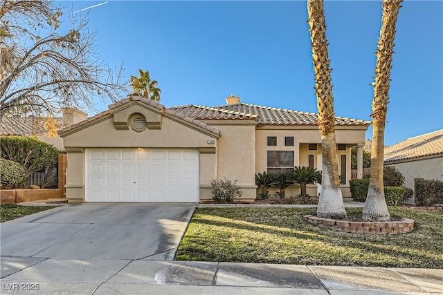 mediterranean / spanish home with a garage and a front lawn