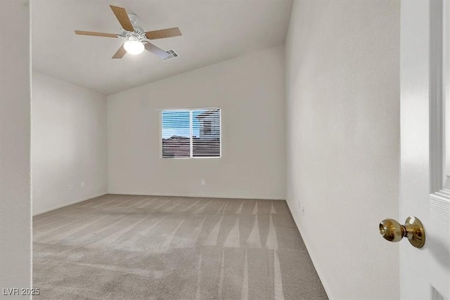 spare room with vaulted ceiling, light carpet, and ceiling fan