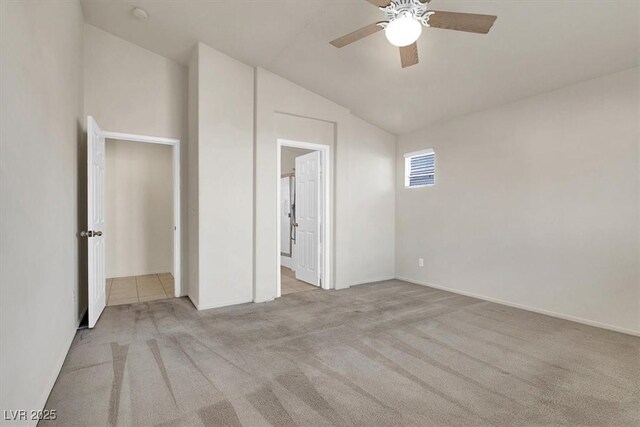 unfurnished bedroom with vaulted ceiling, light colored carpet, and ceiling fan