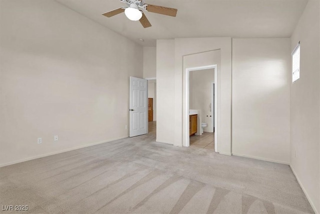 carpeted empty room with ceiling fan and lofted ceiling