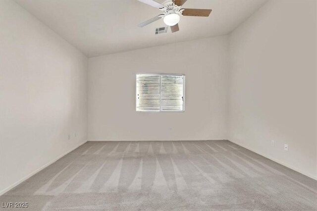 carpeted empty room with ceiling fan and lofted ceiling