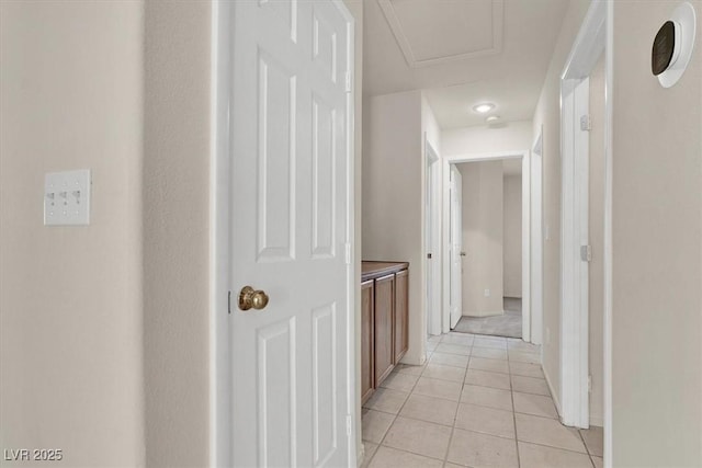 hall featuring light tile patterned flooring