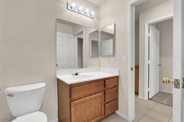 bathroom with vanity, toilet, and tile patterned flooring