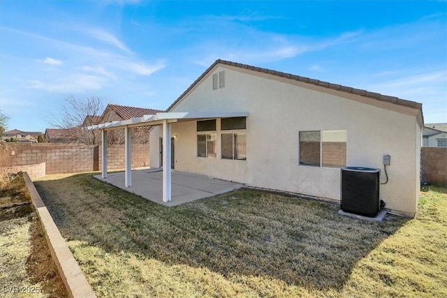 back of property with central AC, a patio, and a lawn