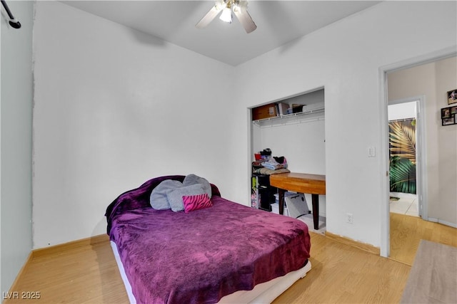 bedroom with hardwood / wood-style floors, a closet, and ceiling fan