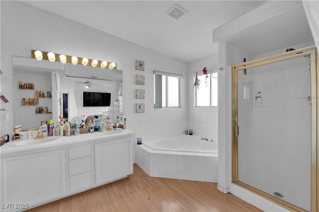 bathroom with vanity, separate shower and tub, hardwood / wood-style floors, and ceiling fan