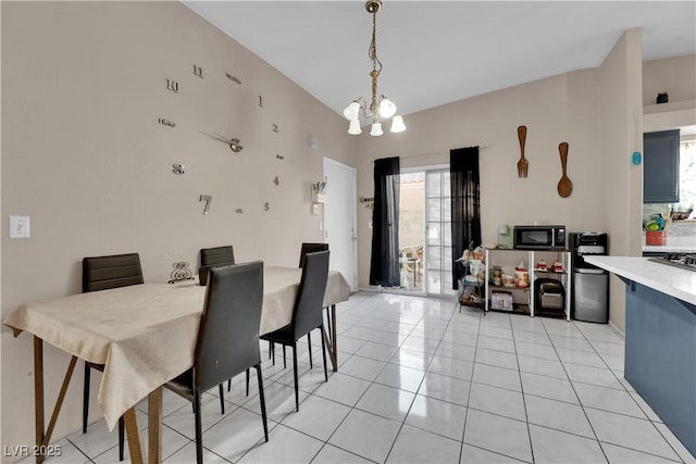 tiled dining room with a notable chandelier