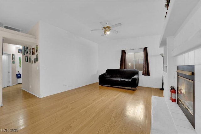 living area featuring ceiling fan and light hardwood / wood-style flooring