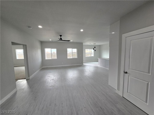 unfurnished room featuring ceiling fan and light wood-type flooring