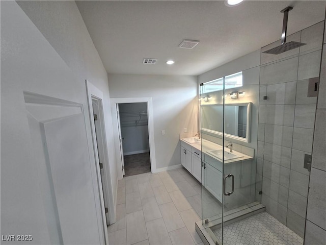 bathroom with vanity and a shower with shower door