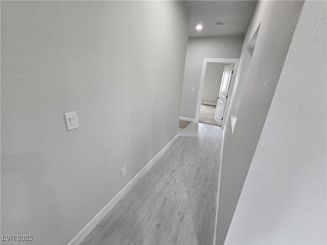 hallway with light hardwood / wood-style flooring